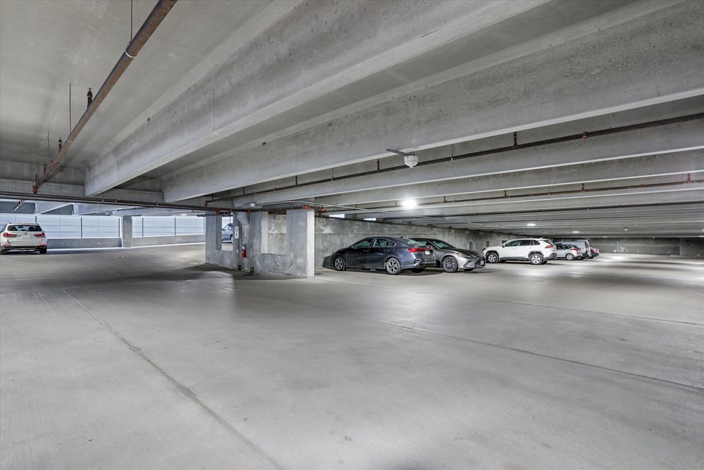 a parking garage with cars parked in it a parking garage with cars parked in it at Beekman on Broadway, Ann Arbor, MI